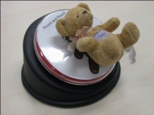 A multi-level single switch device. A small teddy bear is placed on top of the device.