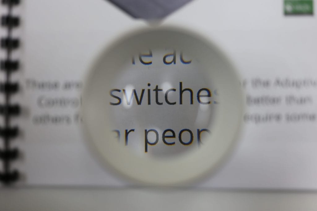 A round magnifier over a portion of a printed page of text